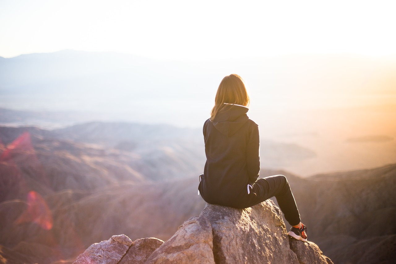 Woman at the top of a Mountain